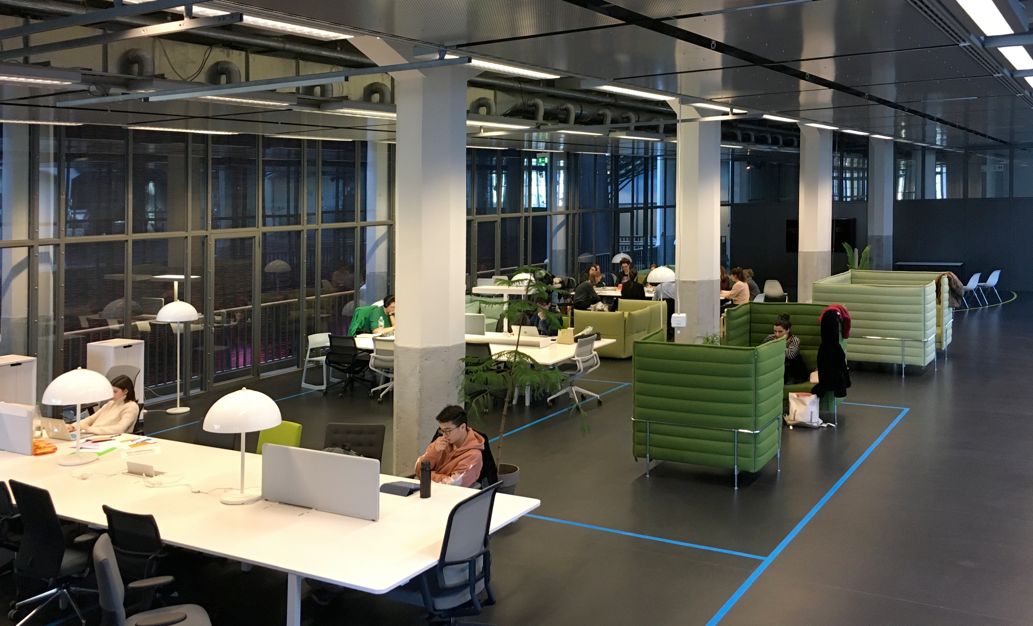 View of the ZKM Media Lounge: tables, chairs and readers