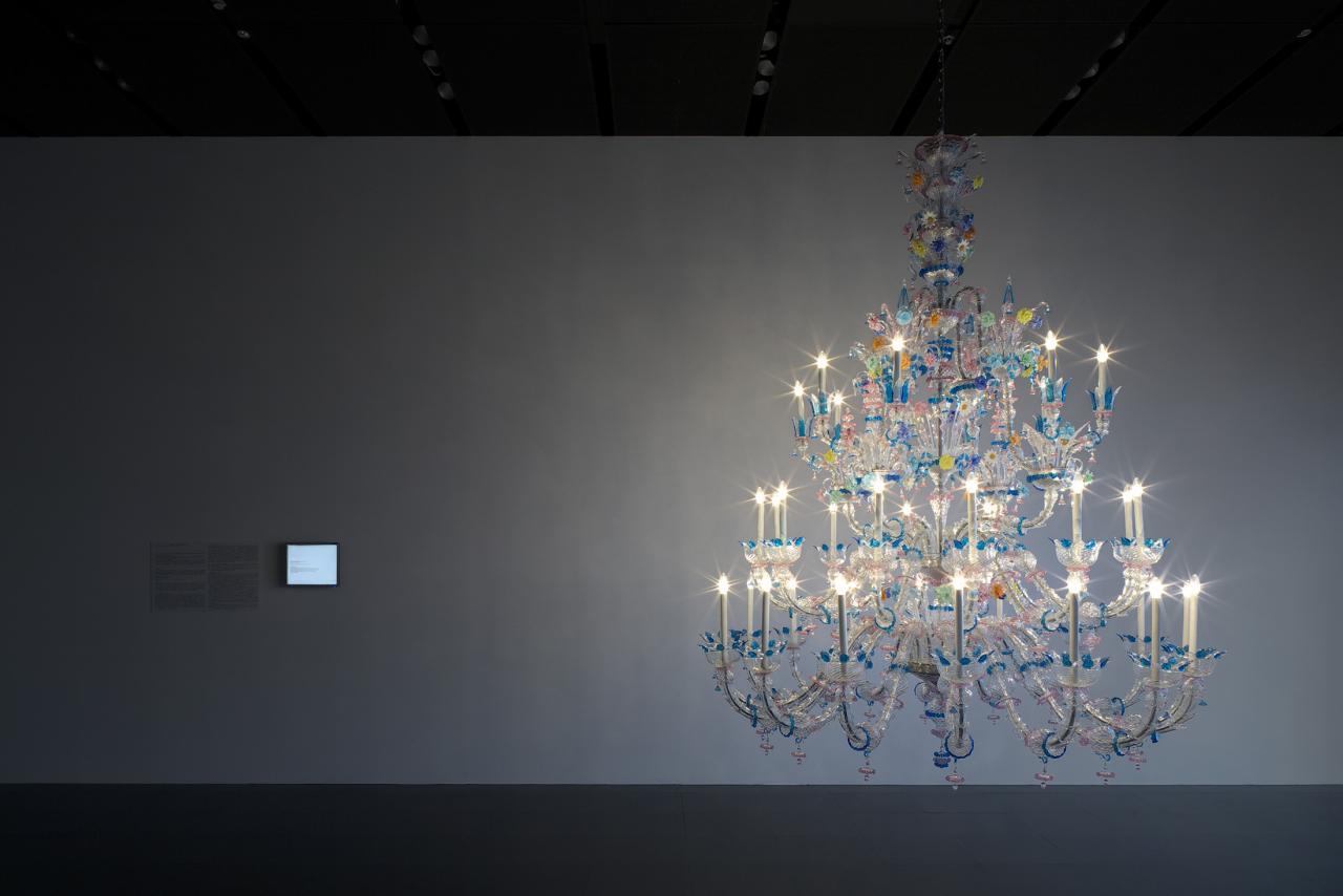 Colourful chandelier in front of a grey wall