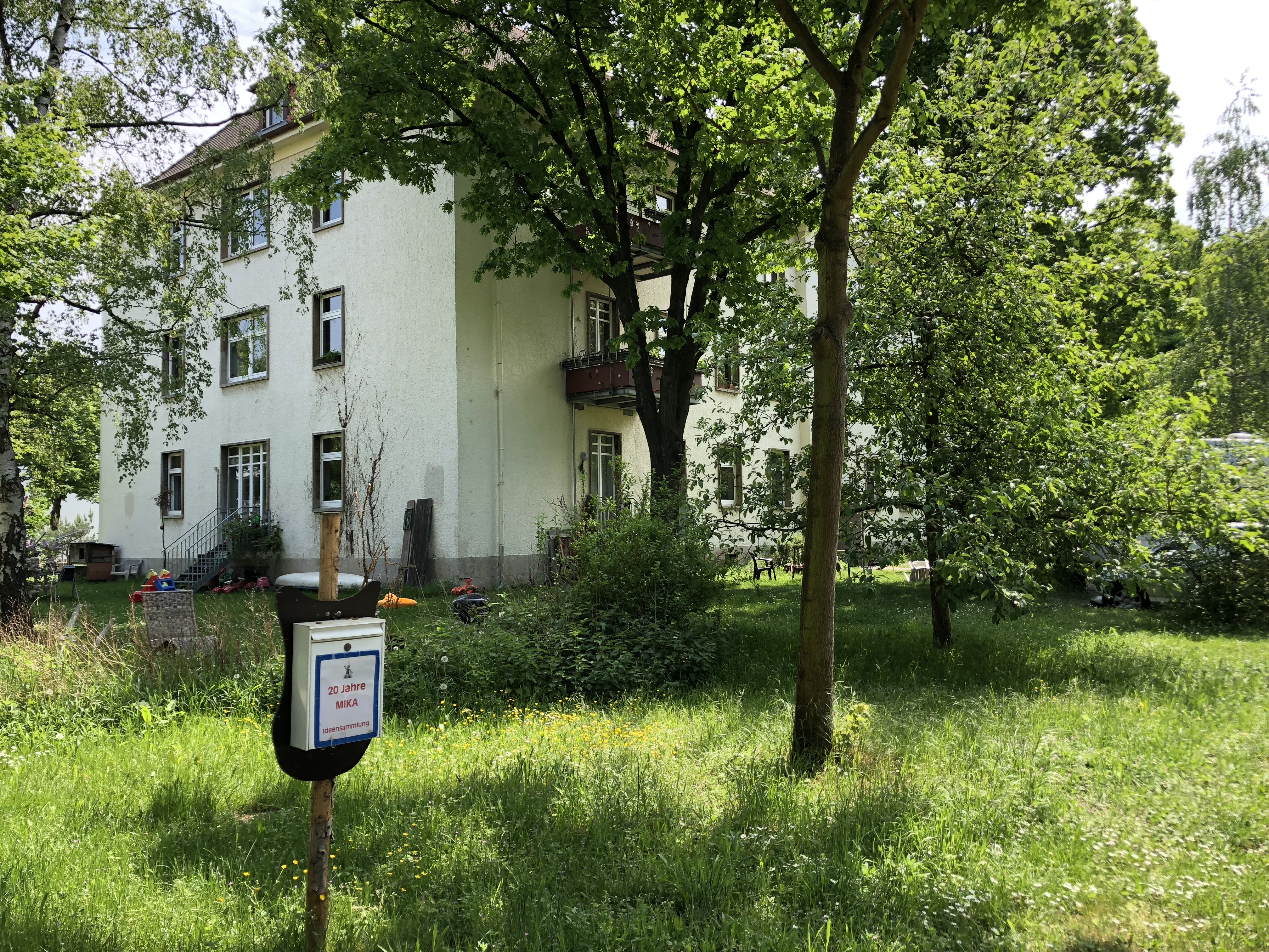 Green garden with a large house