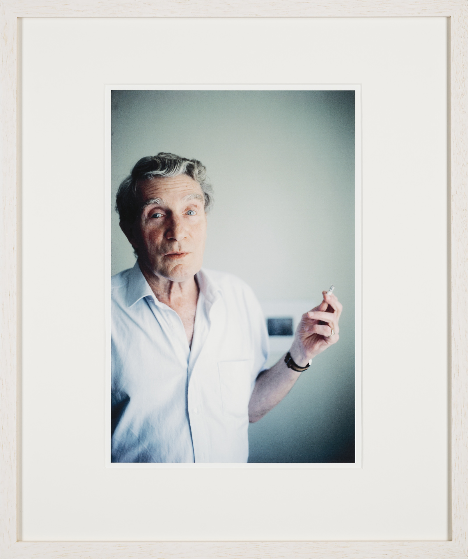 Same morning smoking, what looks like a regular cigarette. On Brion’s pinky his golden seal ring can be seen. Blurred in the background is the black-and-white photograph depicting Burroughs’ blackboard drawings illustrating his lecture The Four Horsemen of the Apocalypse, given at one of the Whole Earth Conferences a little outside of Aix-en- Provence, which also Brion did attend