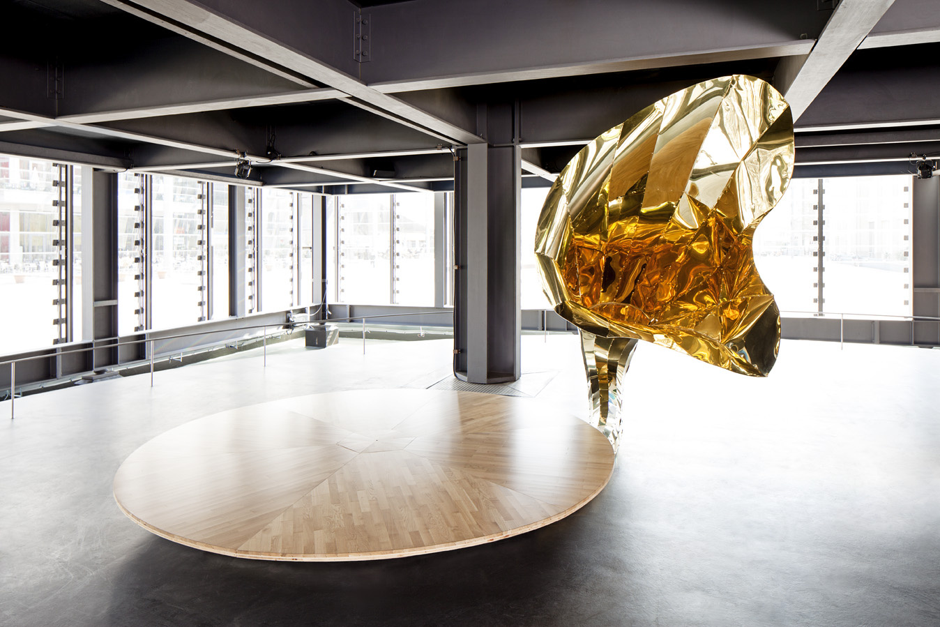 A golden gramophone horn at a large round wooden plate
