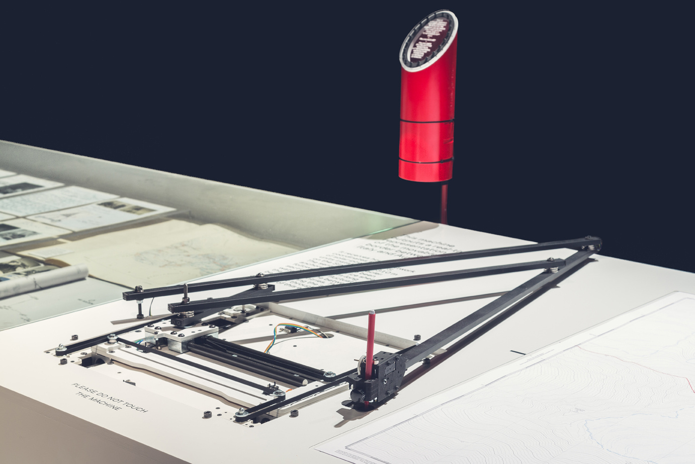 A machine on a table drawing records.