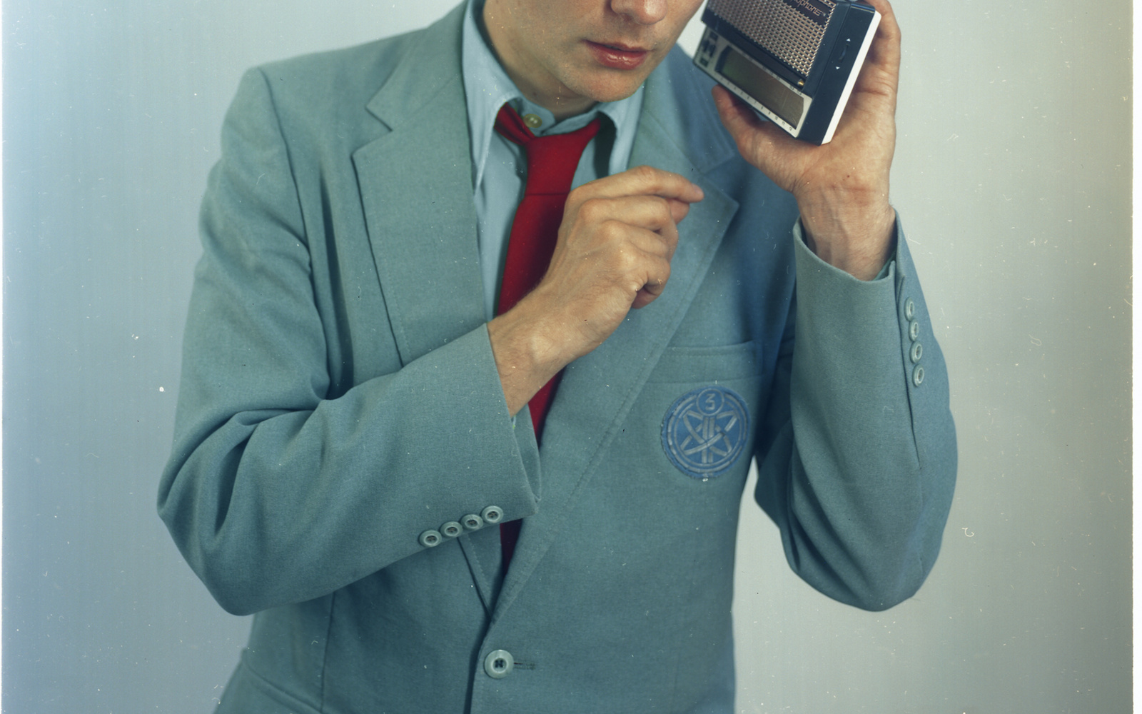 A photo of Felix Kubin in a grey-blue suit with a red tie.