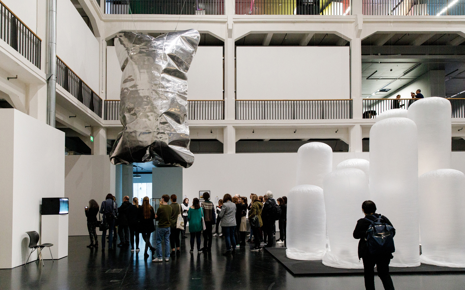 A person stands in front of inflated plastic tubes.