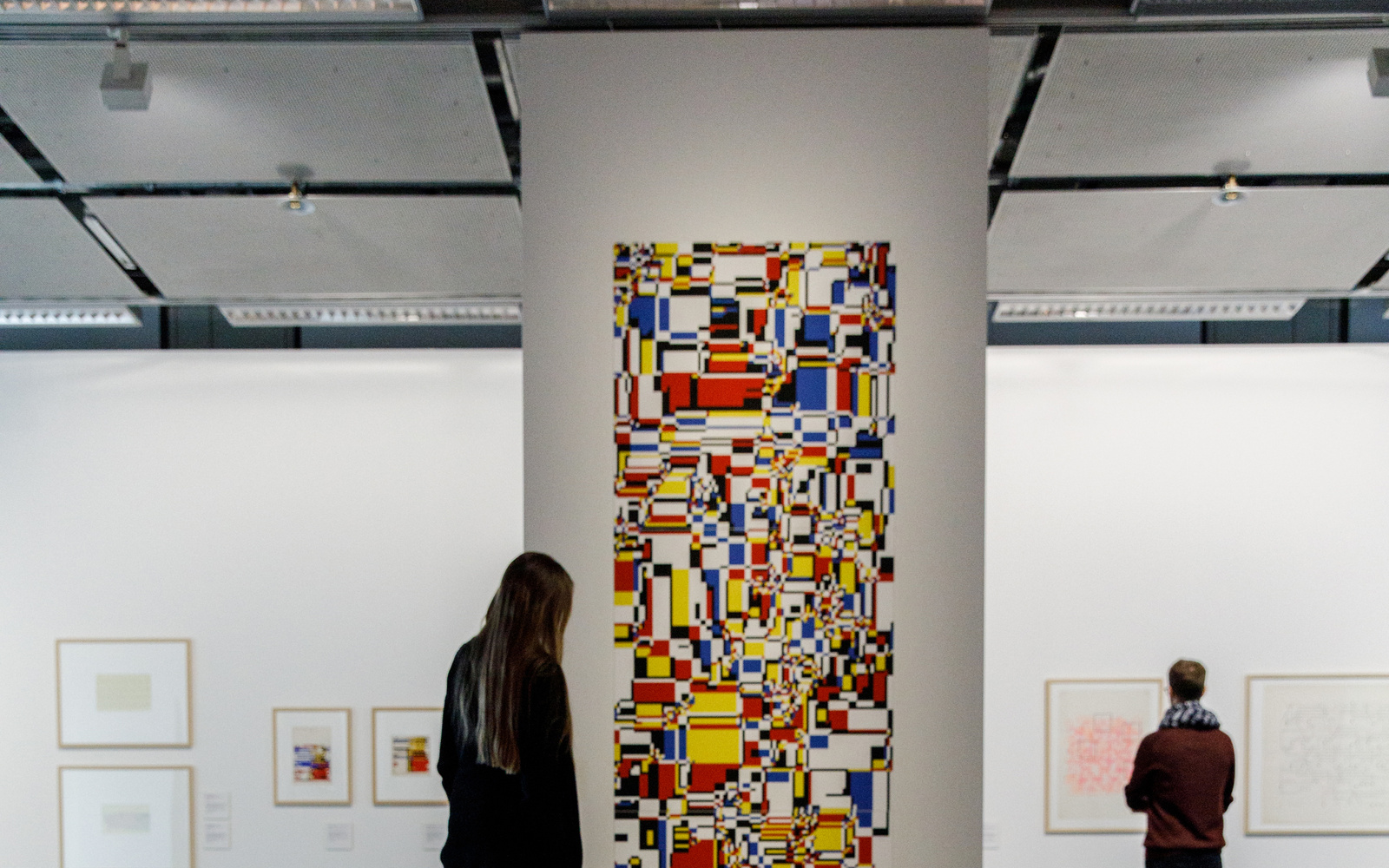A mosaic of colored surfaces extends from the wall to the floor