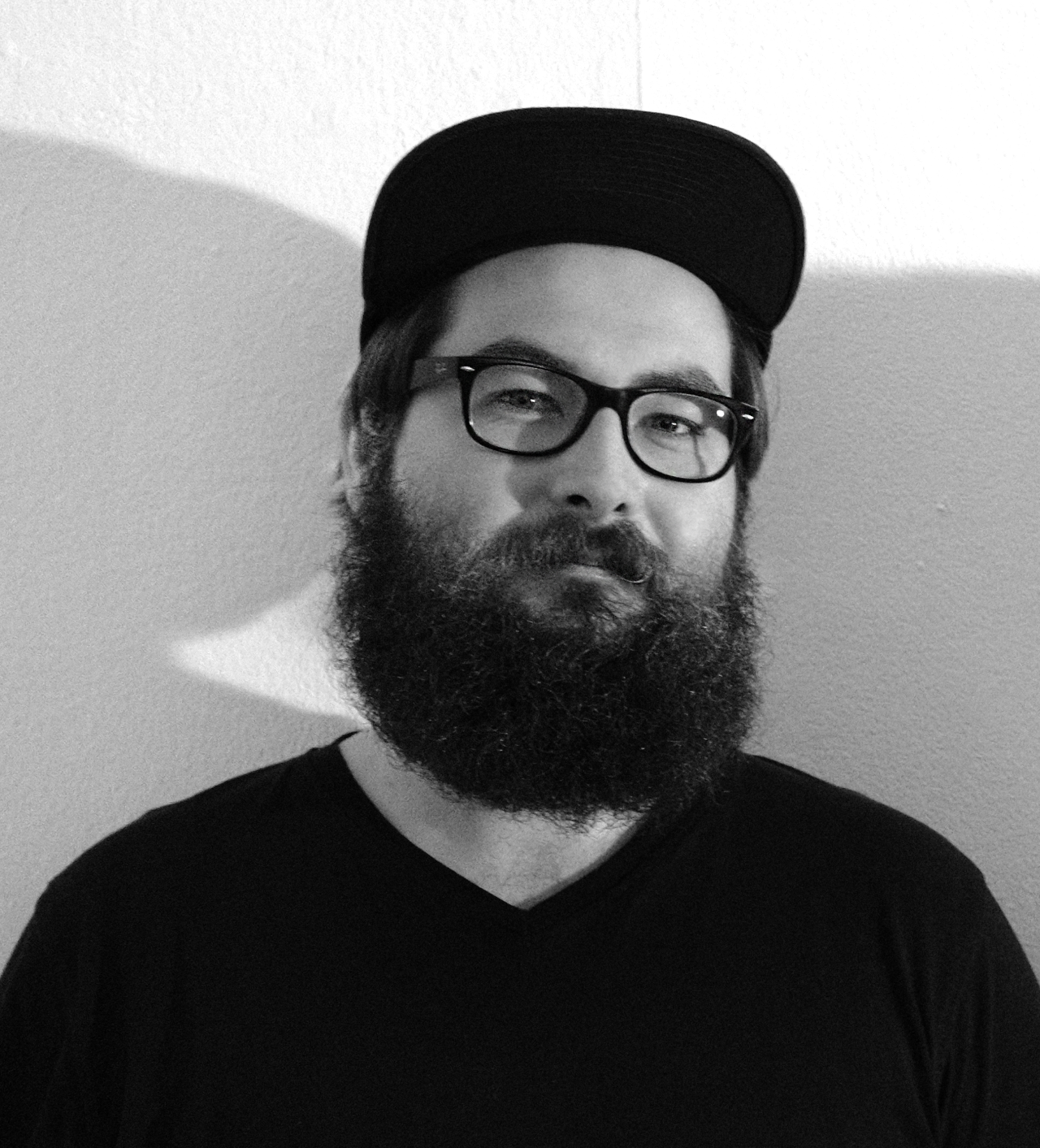 Schwarz-weiß Portrait eines Mannes mit Brille und Vollbart