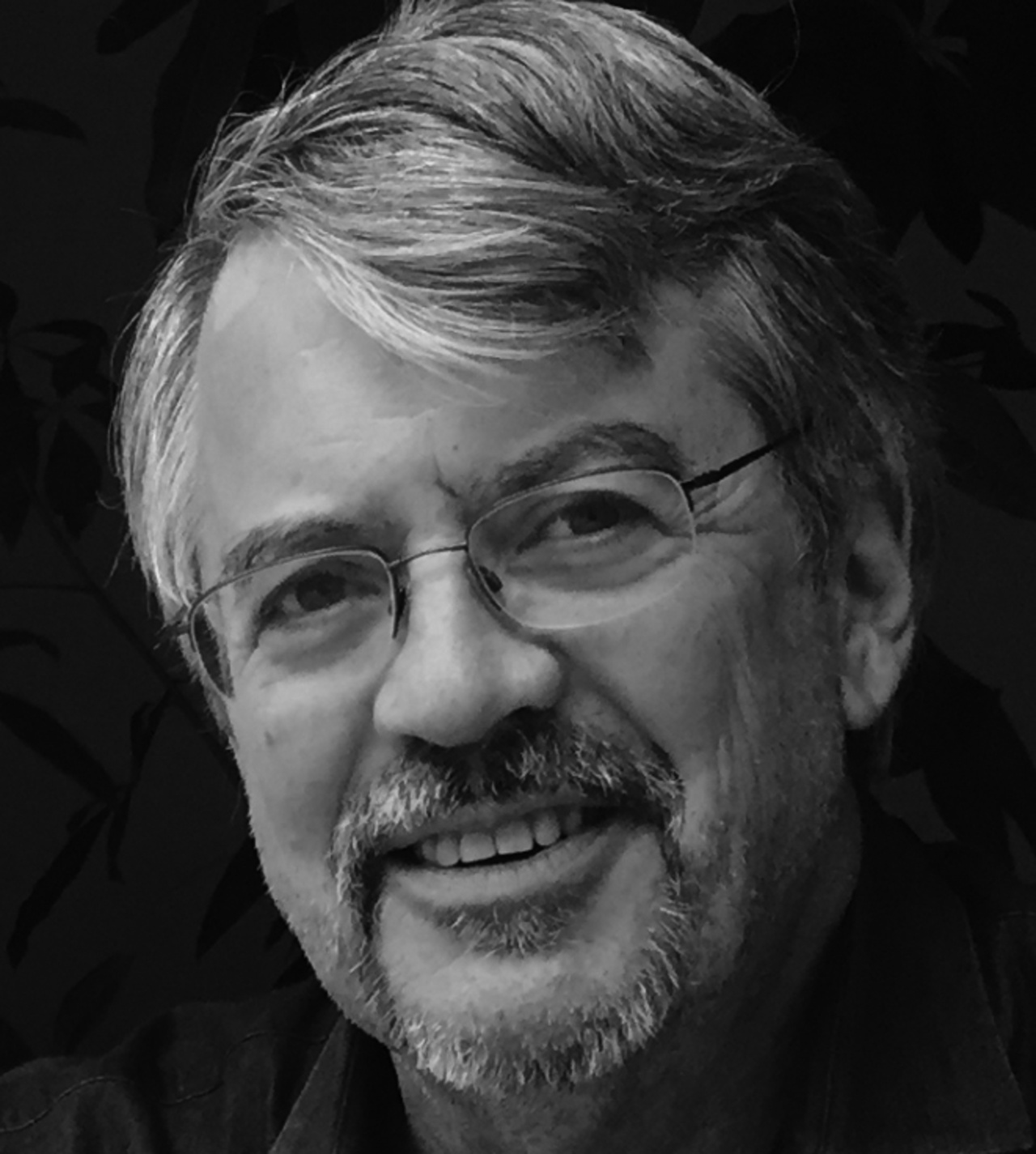 A portrait photo of Lew Tucker is shown. 