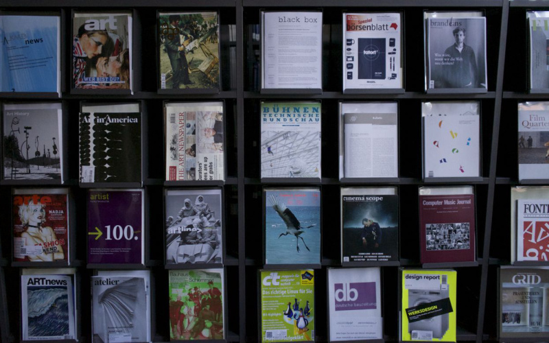 A shelf full of different journals