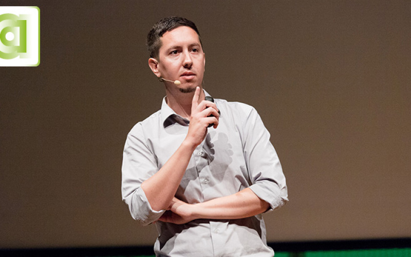 A man is standing on a stage giving a speach