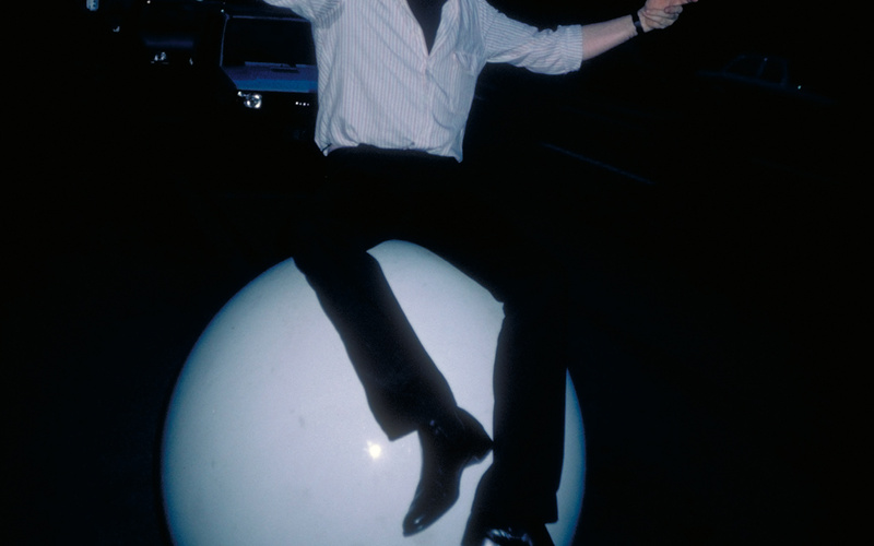 Photography of Gerhard Johann Lischka, sitting on a large white ball