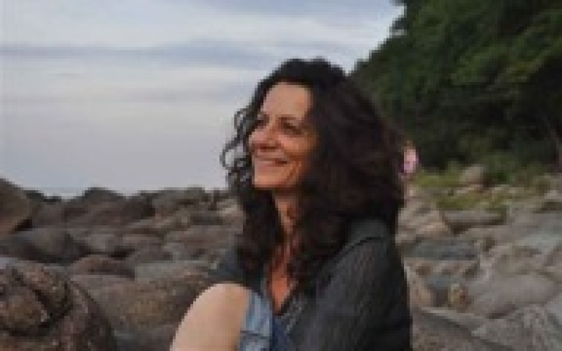 A woman sitting at the beach
