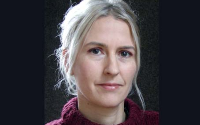 Portrait of Indra Schelble in a red sweater