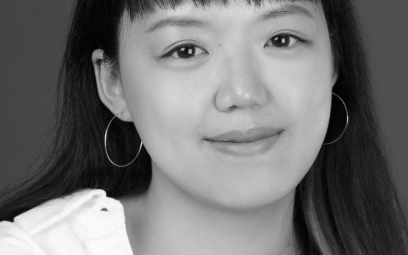 A portrait photo of a person in black and white. 