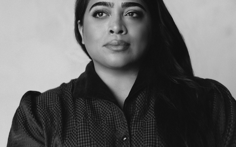 A portrait photo of Nora N. Khan is shown. 