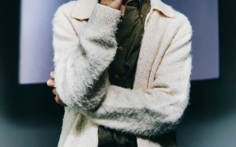 A portrait photo of a person against a blue background. 