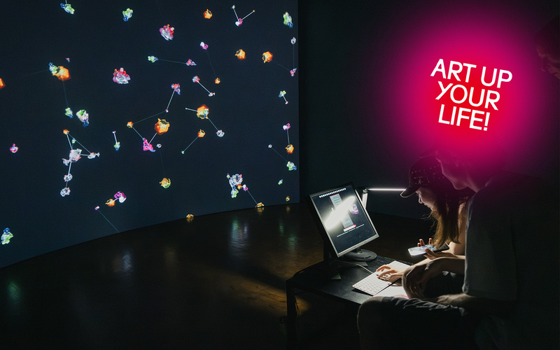 Colorful projections behind a laptop.