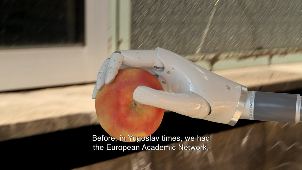 A roboter hand holds an apple