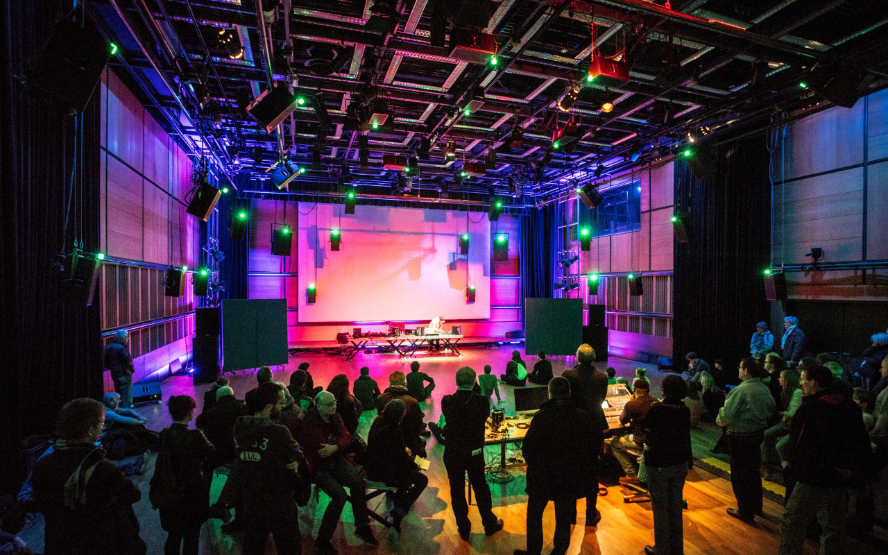 A concert inside the ZKM Klangdom with atmospheric lights.