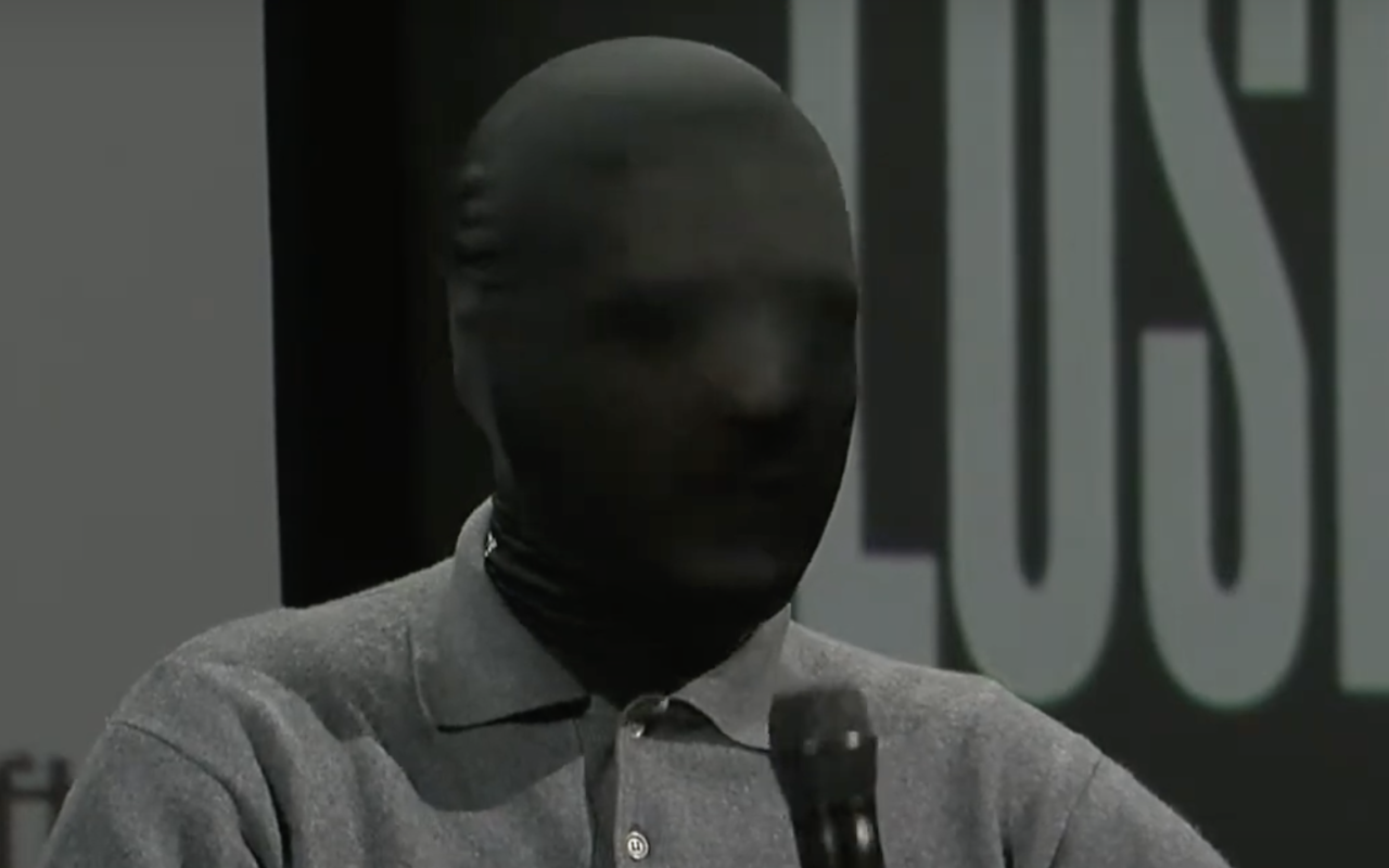 Portrait of Cem A. with a black mask covering his face