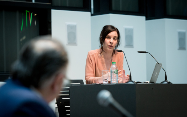 A woman on stage talking to a person from the audience