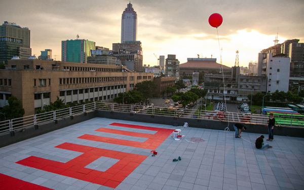 The word "many" in red letters on a roof