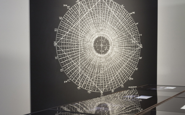 In the background: A circle full of bars. In the foreground: A display table