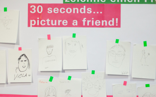 A wall full of handmade portraits