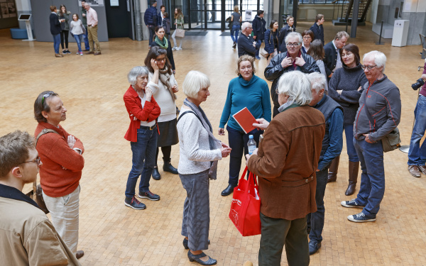 A man distributes books to bystanders