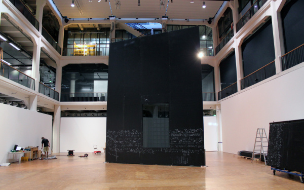 A labeled black wall with a mirror