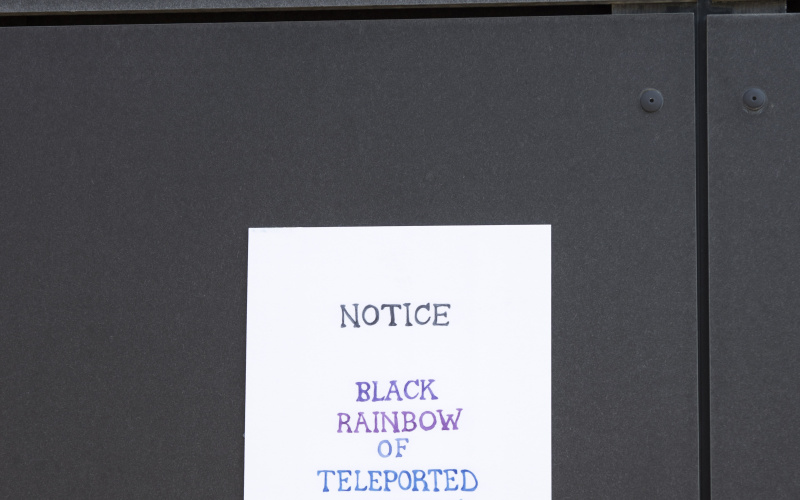 A piece of paper hangs from a fence.