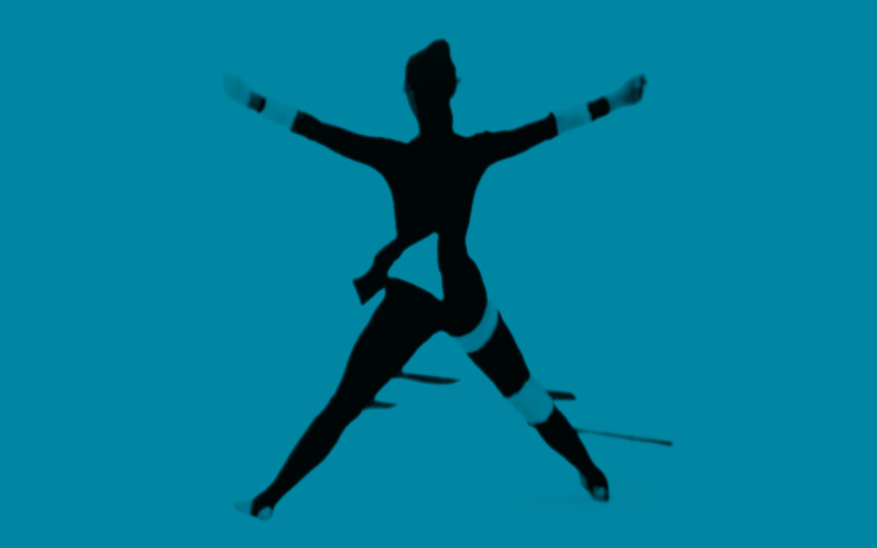 The picture shows a woman from behind with her arms and legs stretched wide.