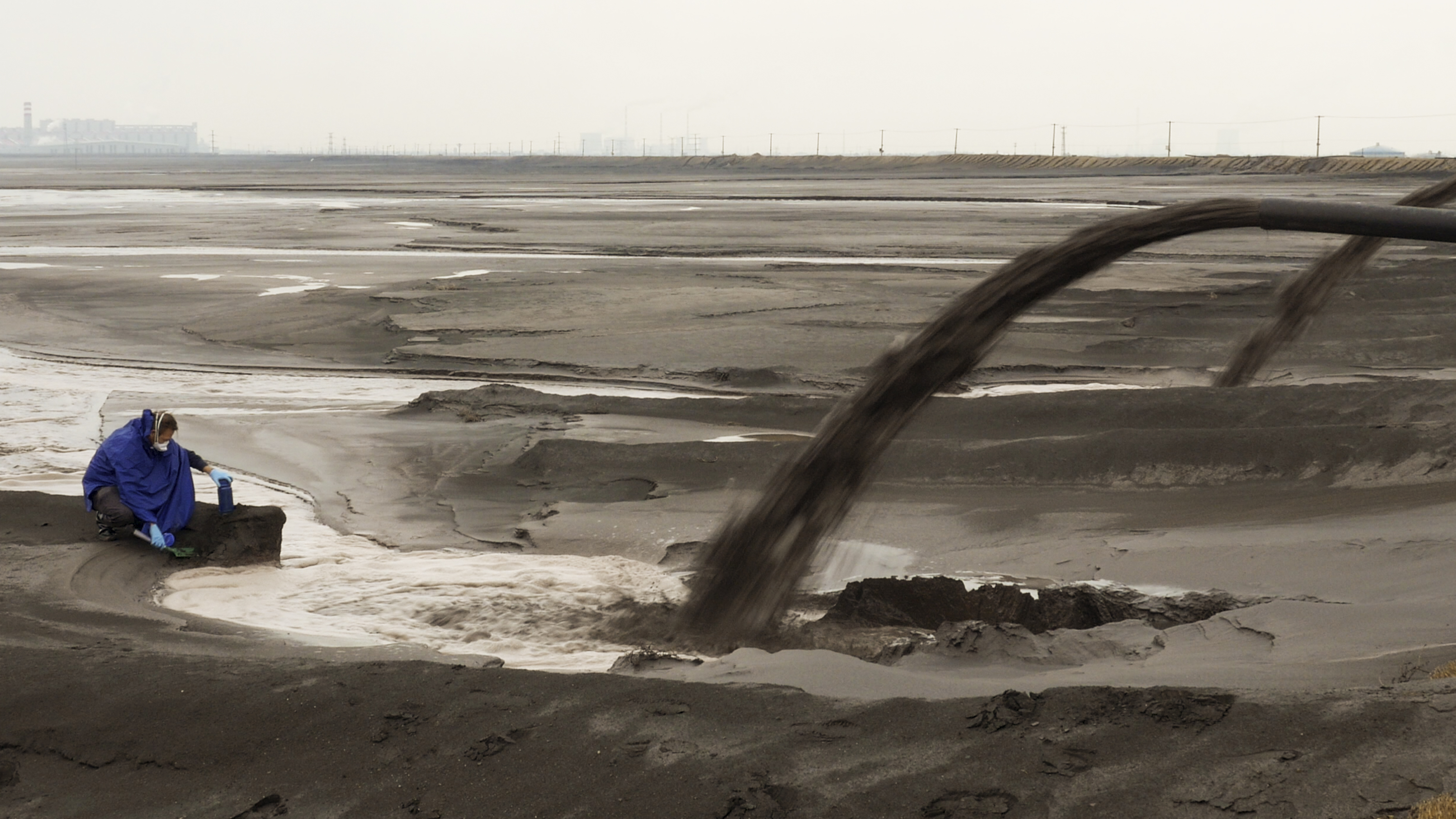 Waste water being pumped into a wide empty plain