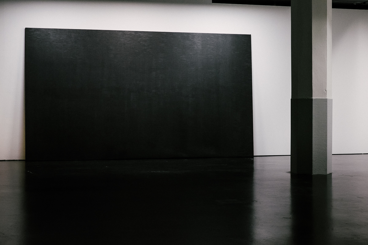 Eine schwarze Leinwand steht im Raum