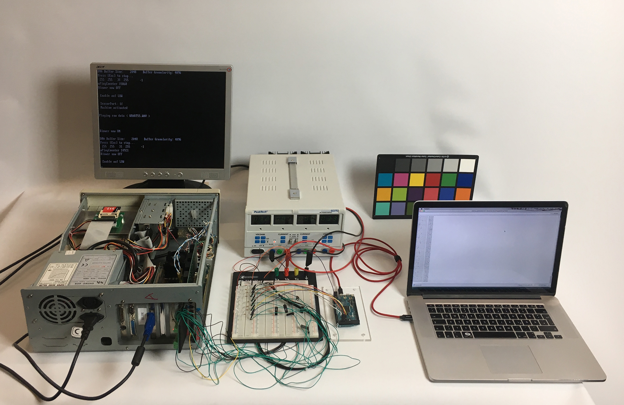 A computer and electronic tools on a table.