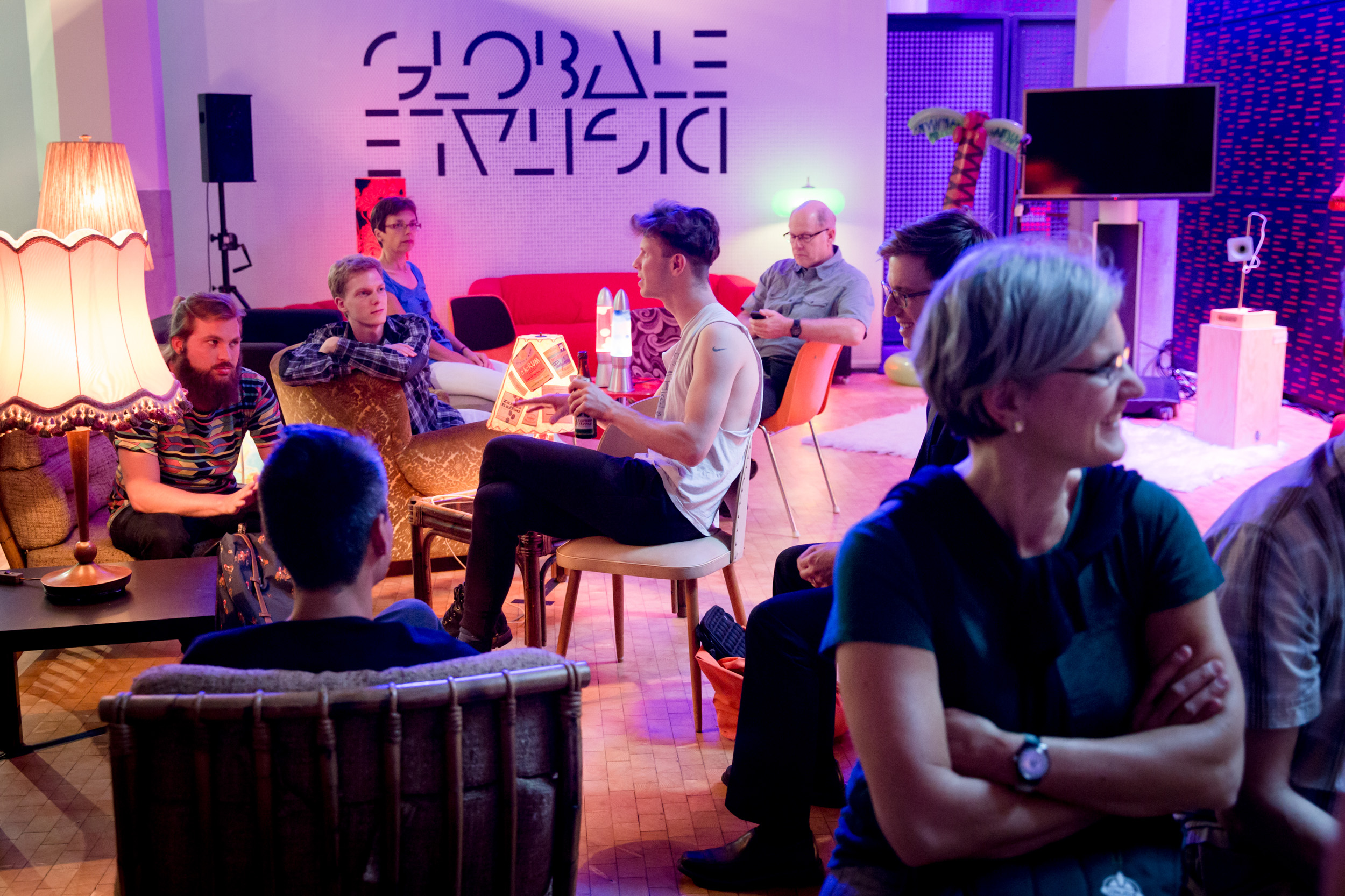About ten people sitting together and chatting in a nice ambience