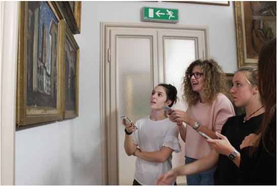 Museum visitors use their mobile phones to play the chat game of the Case Museo di Milano