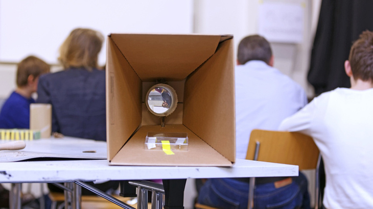 selfmade projector out of cardboard is lying on a table