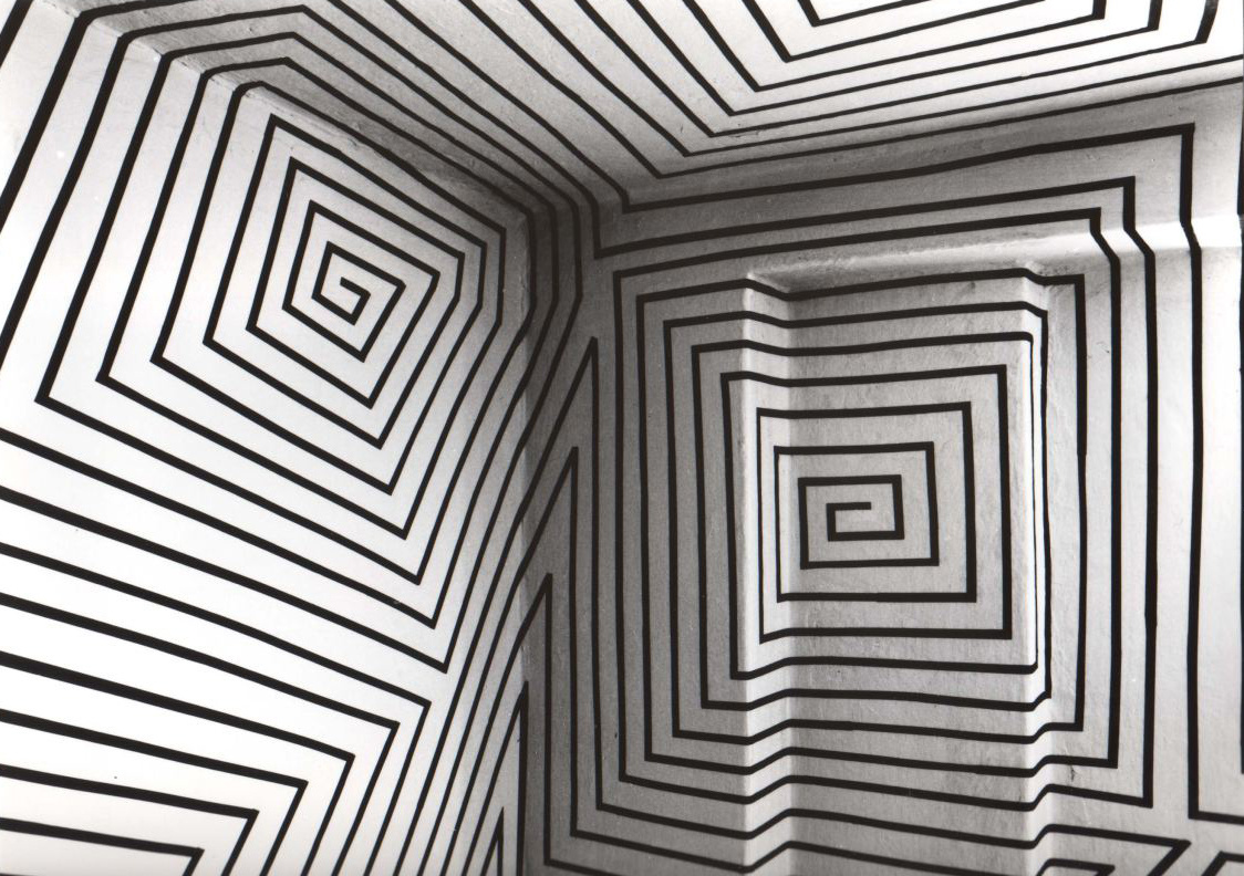 Black orthogonal ornaments spread over an entire room, which is painted white.