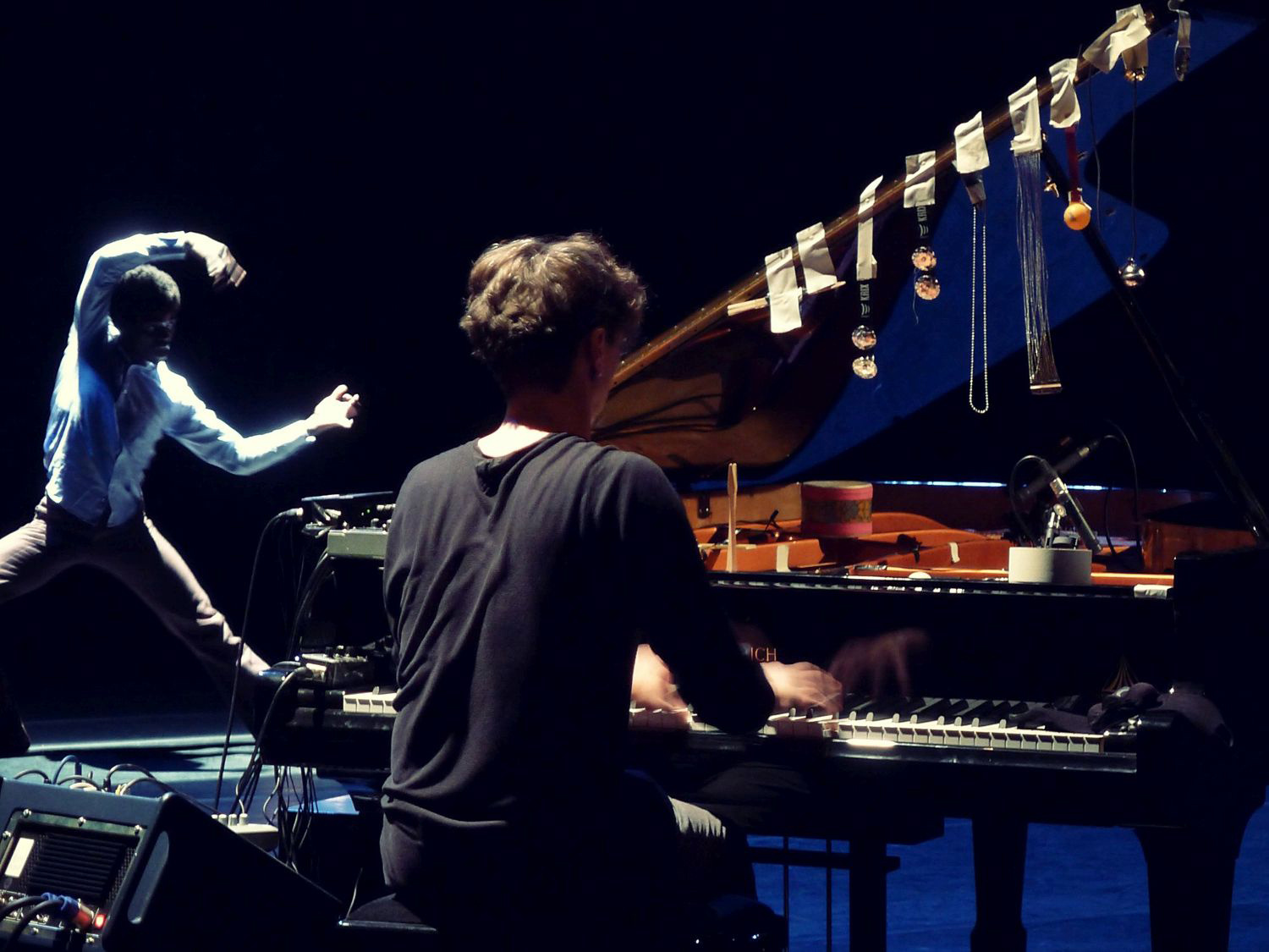 One person playing the piano, left: a dancer