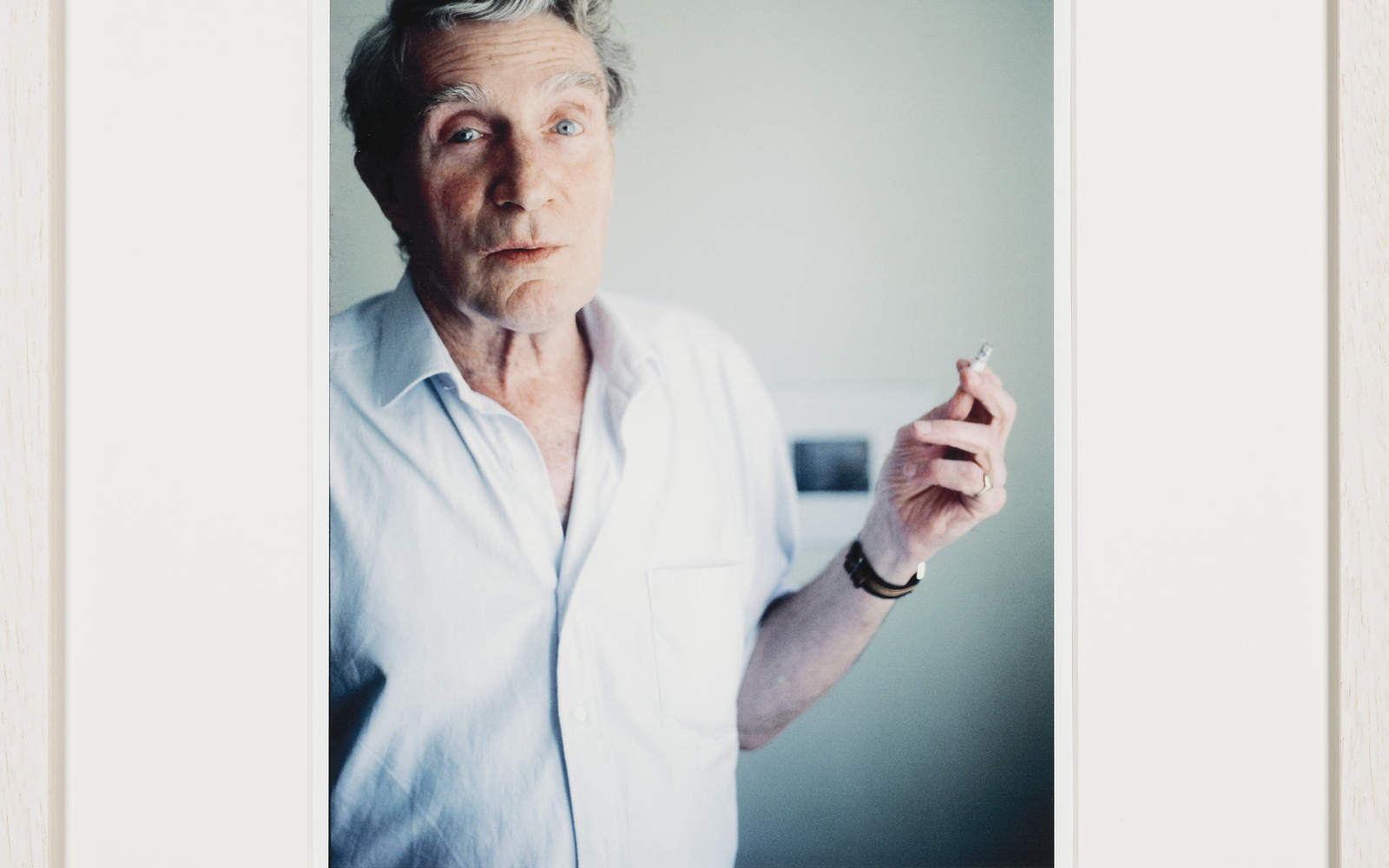Same morning smoking, what looks like a regular cigarette. On Brion’s pinky his golden seal ring can be seen. Blurred in the background is the black-and-white photograph depicting Burroughs’ blackboard drawings illustrating his lecture The Four Horsemen of the Apocalypse, given at one of the Whole Earth Conferences a little outside of Aix-en- Provence, which also Brion did attend