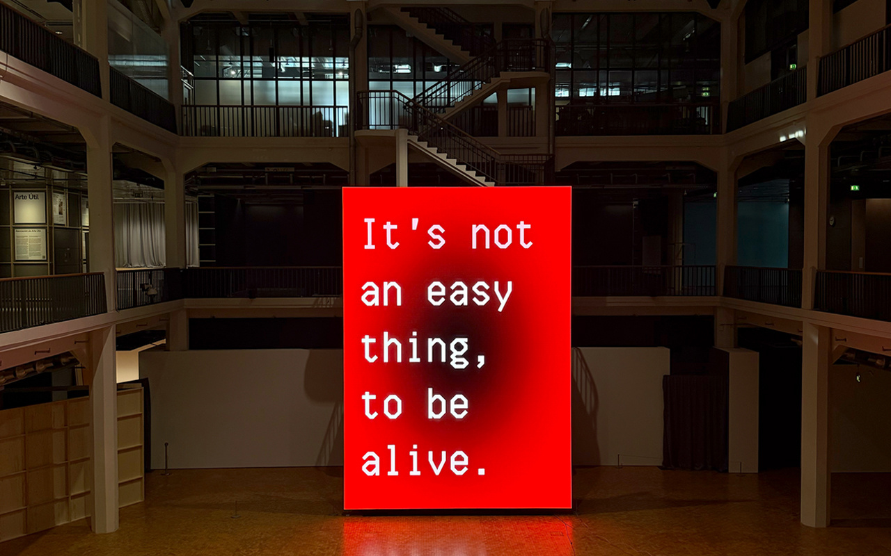 A huge screen displaying Sasha Stiles' work “A Living Poem.”