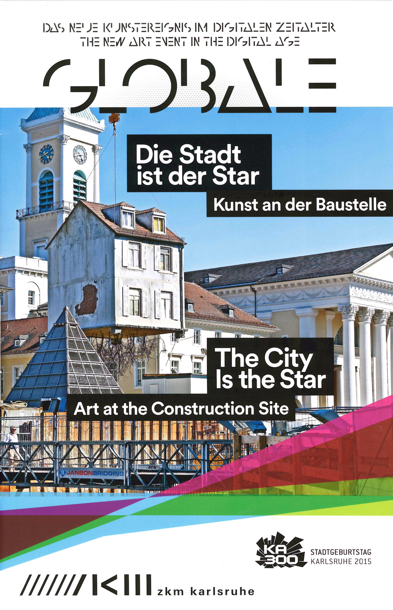 View of the Karlsruhe market place: A house is dangling from a crane. It has roots.