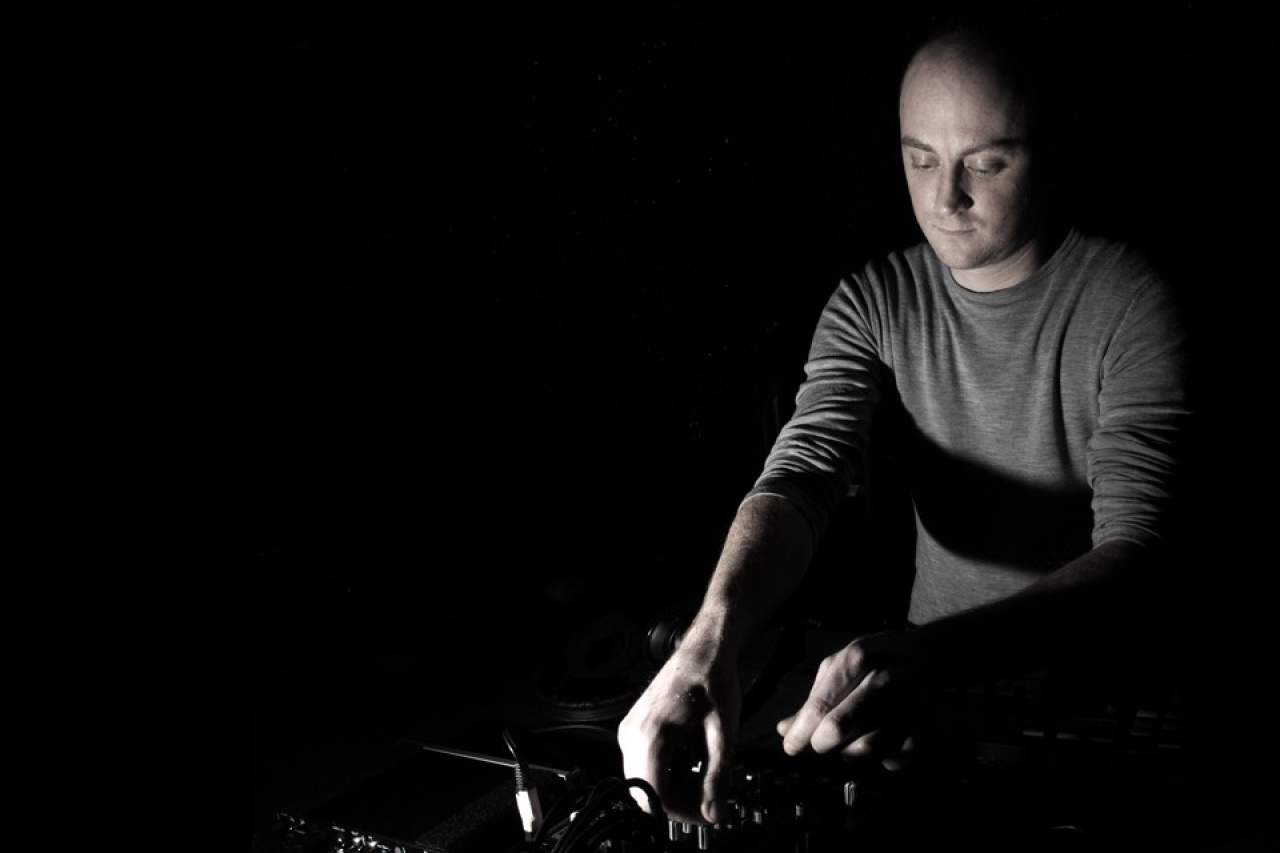 Black and white portrait of a man at the turntables