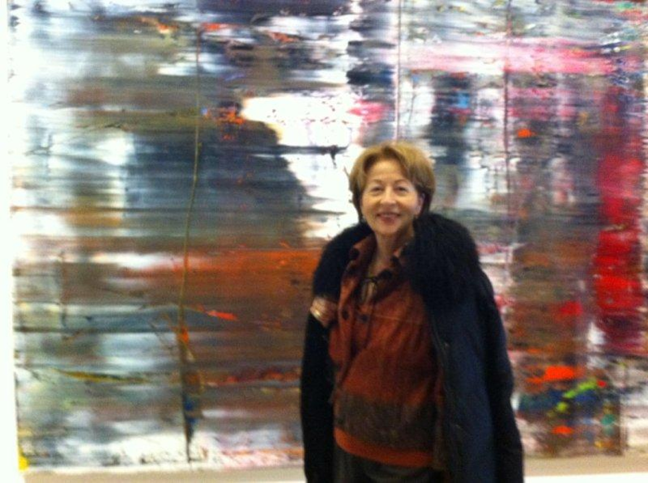 Portrait of a woman in front of a blurred picture