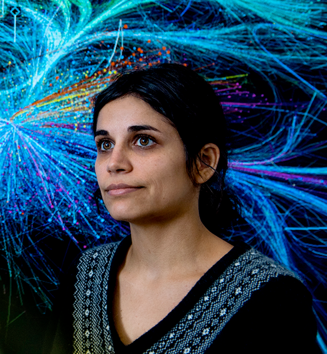 Portrait of Alice Grishchenko in front of a BarabásiLab artwork