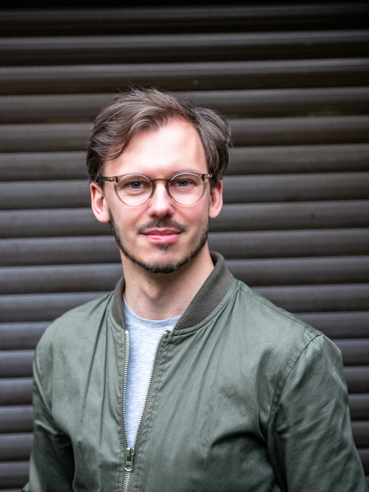 You can see a person with brown hair and glasses. 