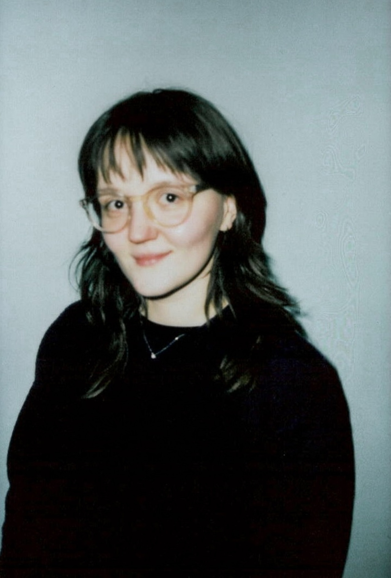 Women with black hair and glasses (Denisa Pubalova) smiling at the camera