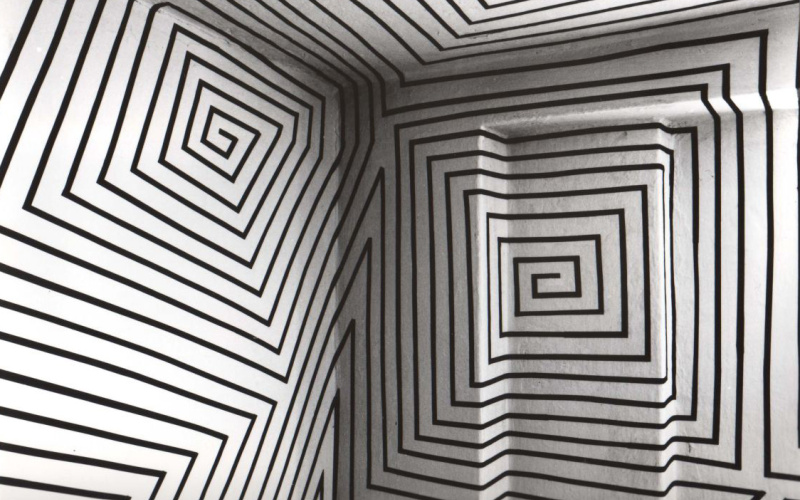 Black orthogonal ornaments spread over an entire room, which is painted white.