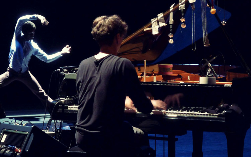 One person playing the piano, left: a dancer