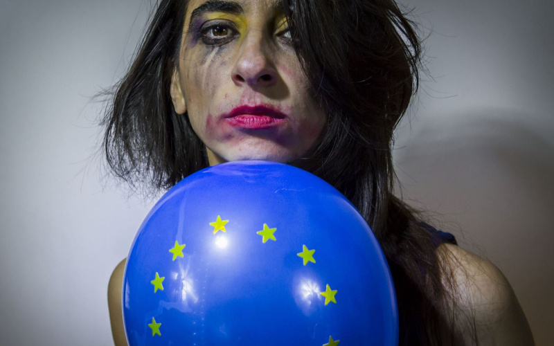 Gesicht einer Frau mit verwischtem Make-Up und Europa-Luftballon